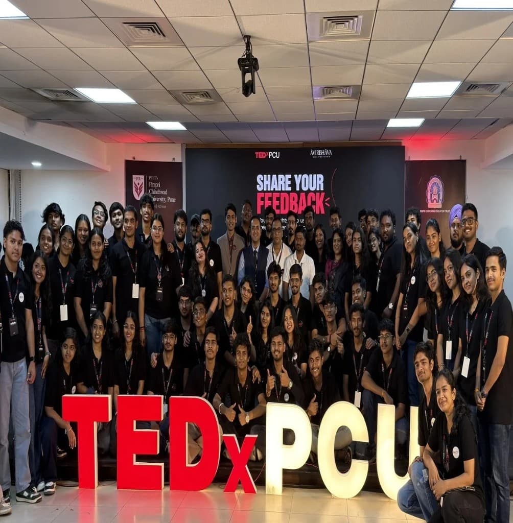 TEDxPCU student organising team posing together on stage at PCU