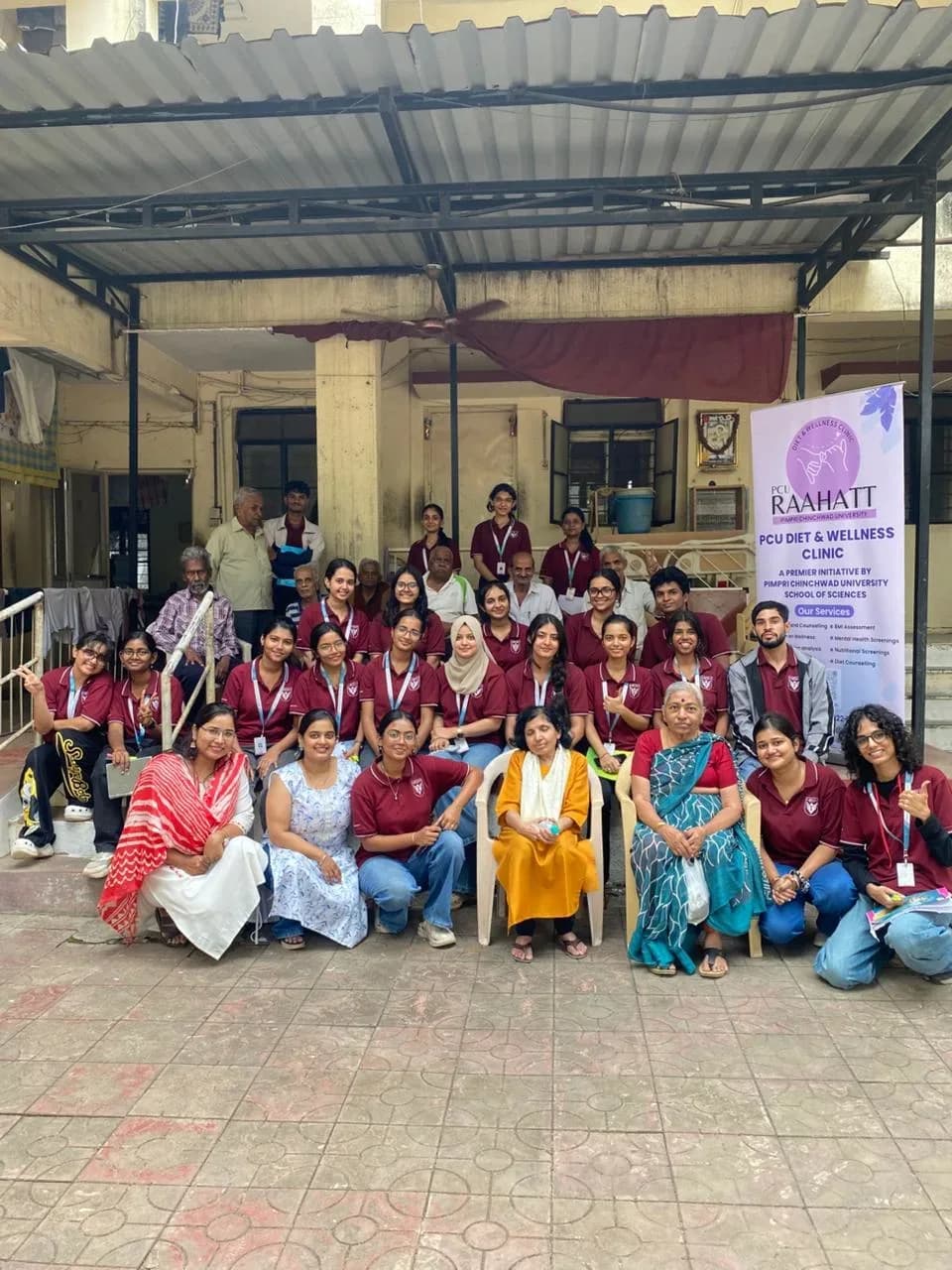 Raahatt team with community members at an outdoor camp